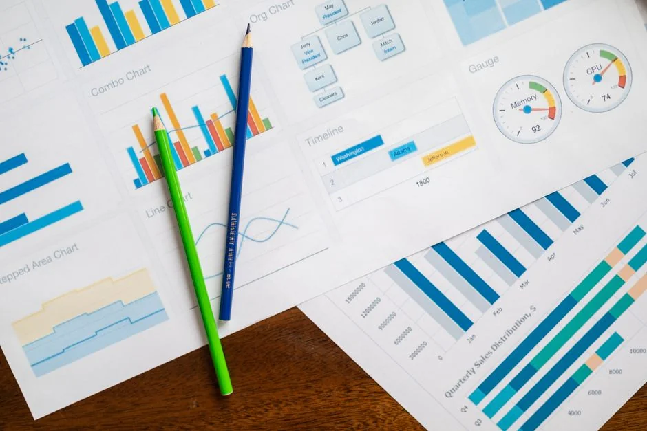 who-we-are Overhead view of e-commerce chart with smartphone calculator and magnifying glass on a table.
